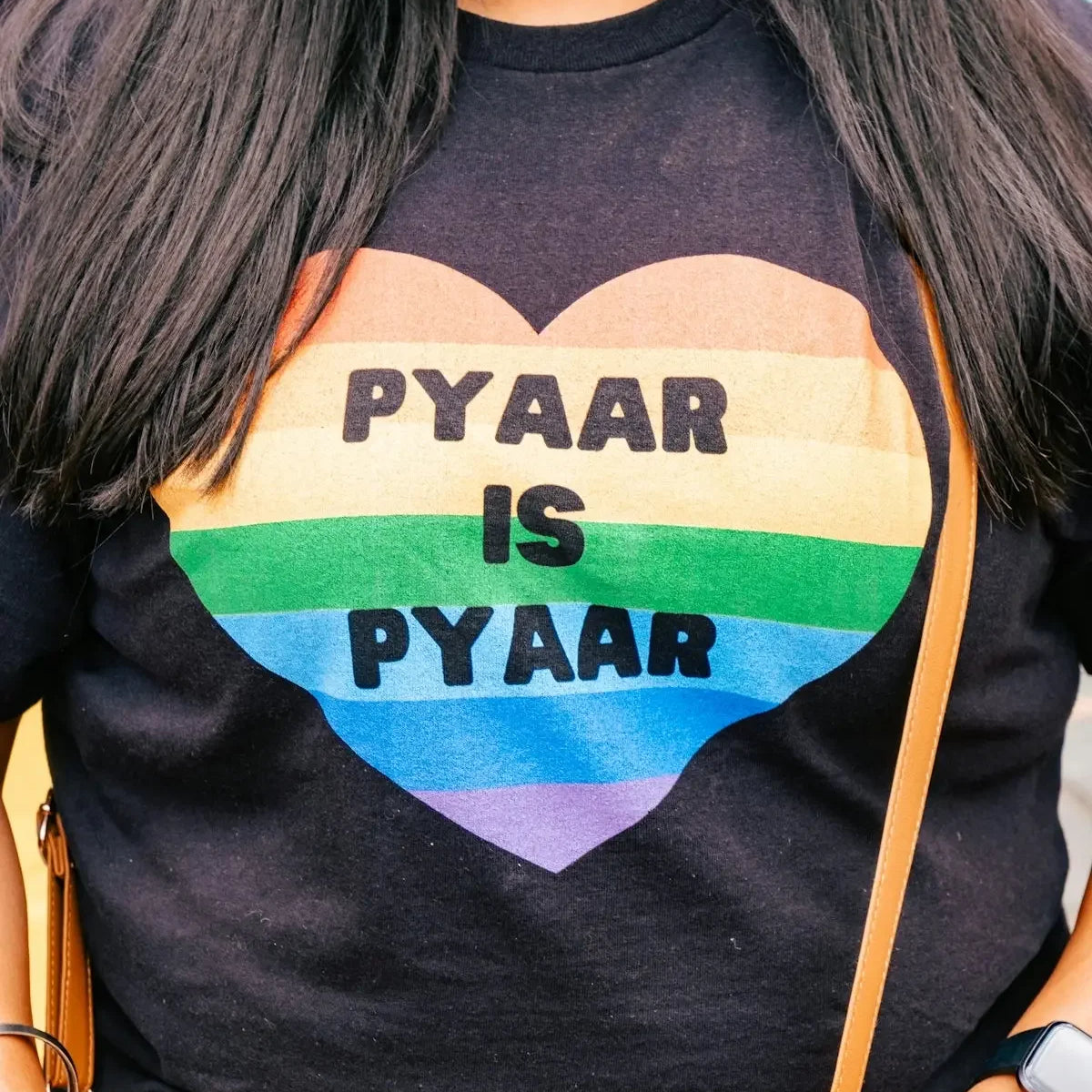 a woman is wearing a gay pride shirt