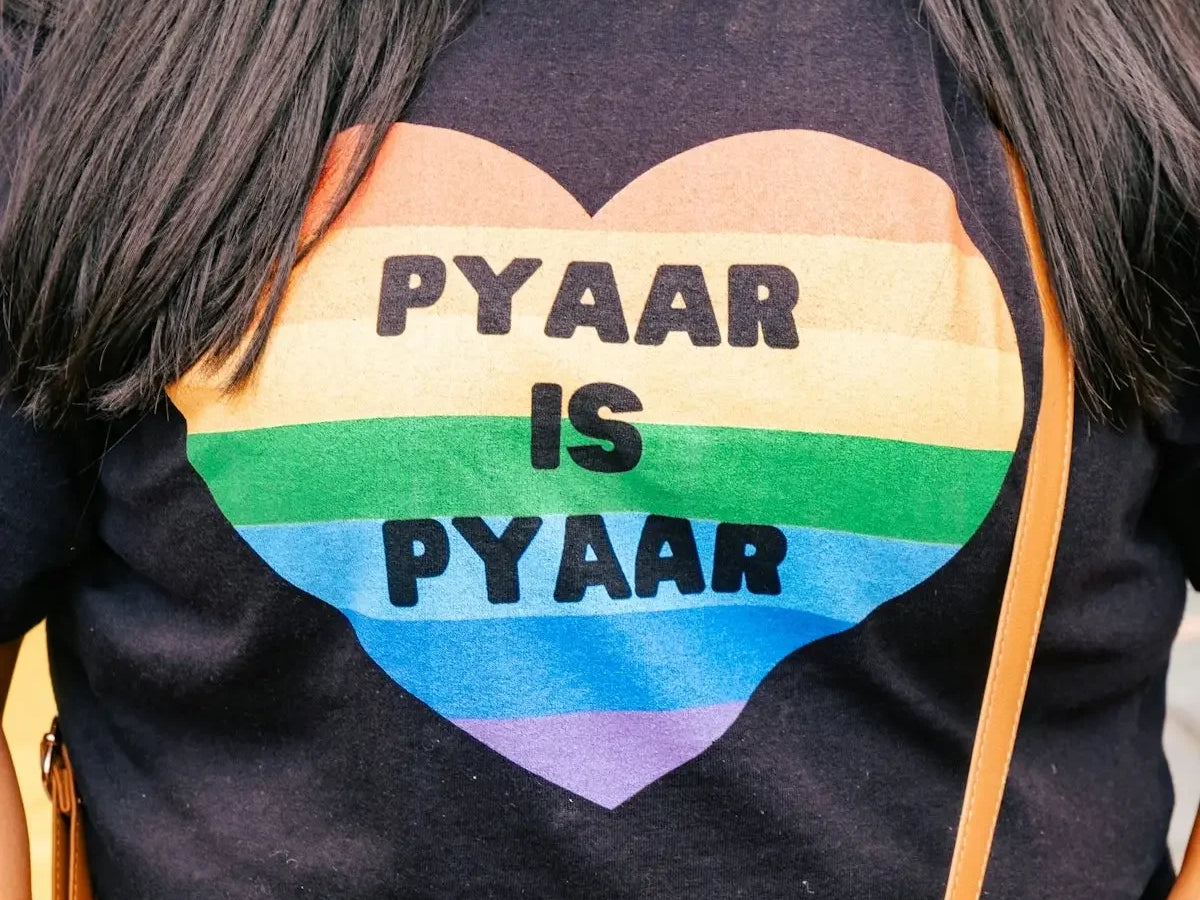 a woman is wearing a gay pride shirt